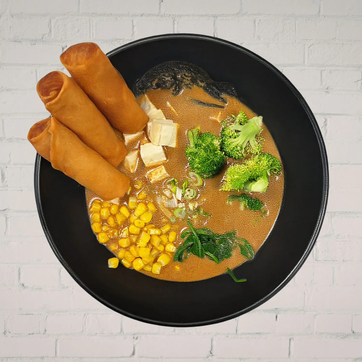 Creamy vegetable curry with spring rolls and fresh veggies at Kaiju Ramen & Curry, a Japanese Curry Restaurant in Isla Vista