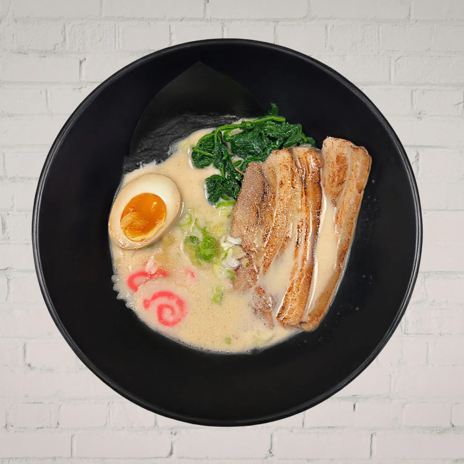 Rich pork bone ramen with chashu, egg and greens at Kaiju Ramen & Curry, a Japanese Curry Restaurant in Isla Vista